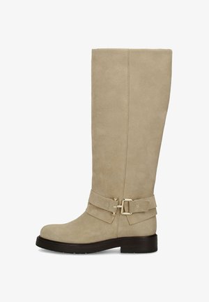 Beige suede knee-high boot with a low black heel, round toe, and decorative strap with gold buckle around the ankle.