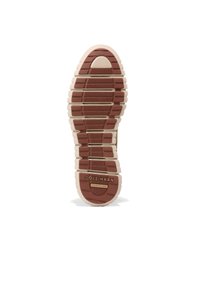 Sneakerová podrážka Cole Haan v světlé béžové a hnědé barvě, s texturovanou gumou, horizontálními drážkami a značkováním v oblasti paty.
