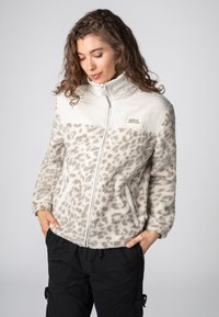 Fellimitat-Jacke in Creme mit braunem Leopardenmuster, mit hohem Kragen, Frontreißverschluss und Seitentaschen; weiche Textur und lockere Passform.