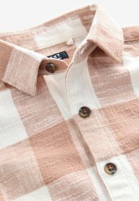 Next Pluus - rust brown