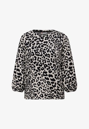 Leren top met een luipaardprint en lange, iets opgeblazen mouwen. Kleurenschema met zwarte vlekken op een lichtbeige achtergrond. Klassieke ronde hals.