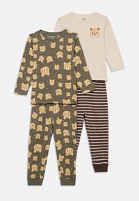 Two sets of children's pajamas: one with a green top featuring bear prints, the other in beige with a bear face; striped brown pants.