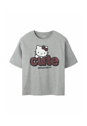 T-shirt gris à manches courtes avec le personnage Hello Kitty, un nœud et le mot "cute" en grandes lettres au-dessus du texte "Hello Kitty".