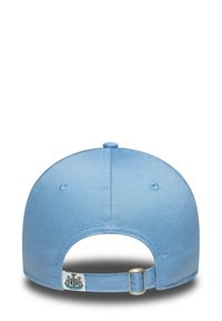 Light blue baseball cap viewed from the back, featuring an adjustable strap with a small Newcastle United logo tag.