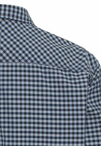 Camicia a quadri con motivo blu e nero, colletto classico e tessuto liscio. Cuciture visibili lungo la cucitura della spalla.
