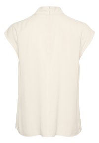 Short-sleeve blouse in a soft beige fabric with a collared neckline and back zipper. Features a relaxed fit and curved hemline.