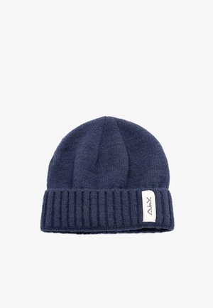 Cappello a cuffia lavorato a maglia blu navy con risvolto a coste e una etichetta tessuta. La trama è morbida con un motivo uniforme su tutta la superficie.