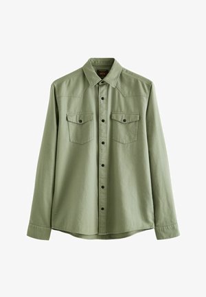 Green long-sleeve shirt made of soft fabric, featuring two front pockets, black buttons, and a pointed collar with yoke detailing.