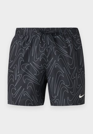 Shorts de sport noirs avec motifs abstraits blancs en forme de virgule, taille élastique, cordon de serrage, et petit logo Nike blanc en bas de la jambe droite.