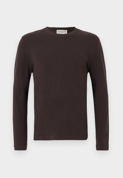 Tumepruun pikkade varrukatega ümmarguse kaelusega kampsun, mille allääres on sirge lõige ja kaeluse sees silt.