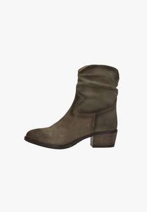 Olive green suede ankle boot with slouched upper, round toe, and a stacked wood heel. Contrast stitching along the seams.