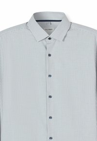 Button-up shirt in light blue with horizontal textured stripes, featuring a buttoned collar and dark blue buttons on the front.