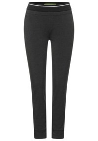 Svarta, tightade träningsoverkallsbyxor med ett brett midjeband som har en kontrasterande kant. Mjuk tyg med en slät yta, som smalnar av vid anklarna.