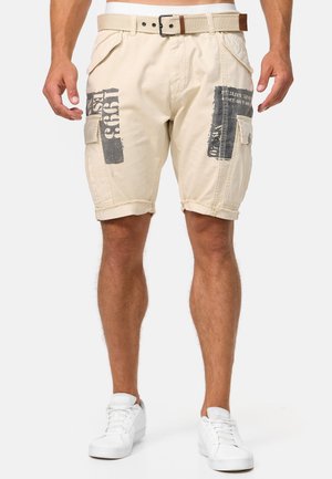 Beige cargo shorts feature a stitched hem, two side pockets, and printed details in dark gray. Includes a tan belt with a silver buckle.