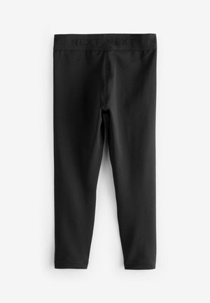 Leggings neri con una texture liscia, cintura elasticizzata con la scritta "NEXT" e una silhouette aderente che arriva fino alle caviglie.
