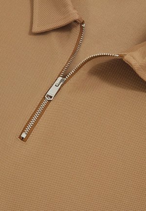 Brown textured polo shirt with a zipper, featuring a collared neck and fine detailing in the zipper hardware.