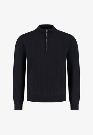 Marineblauwe gebreide trui met een hoge kraag en een kwart ritssluiting. Beschikt over een gestructureerd patroon en ribgebreide manchetten en zoom.