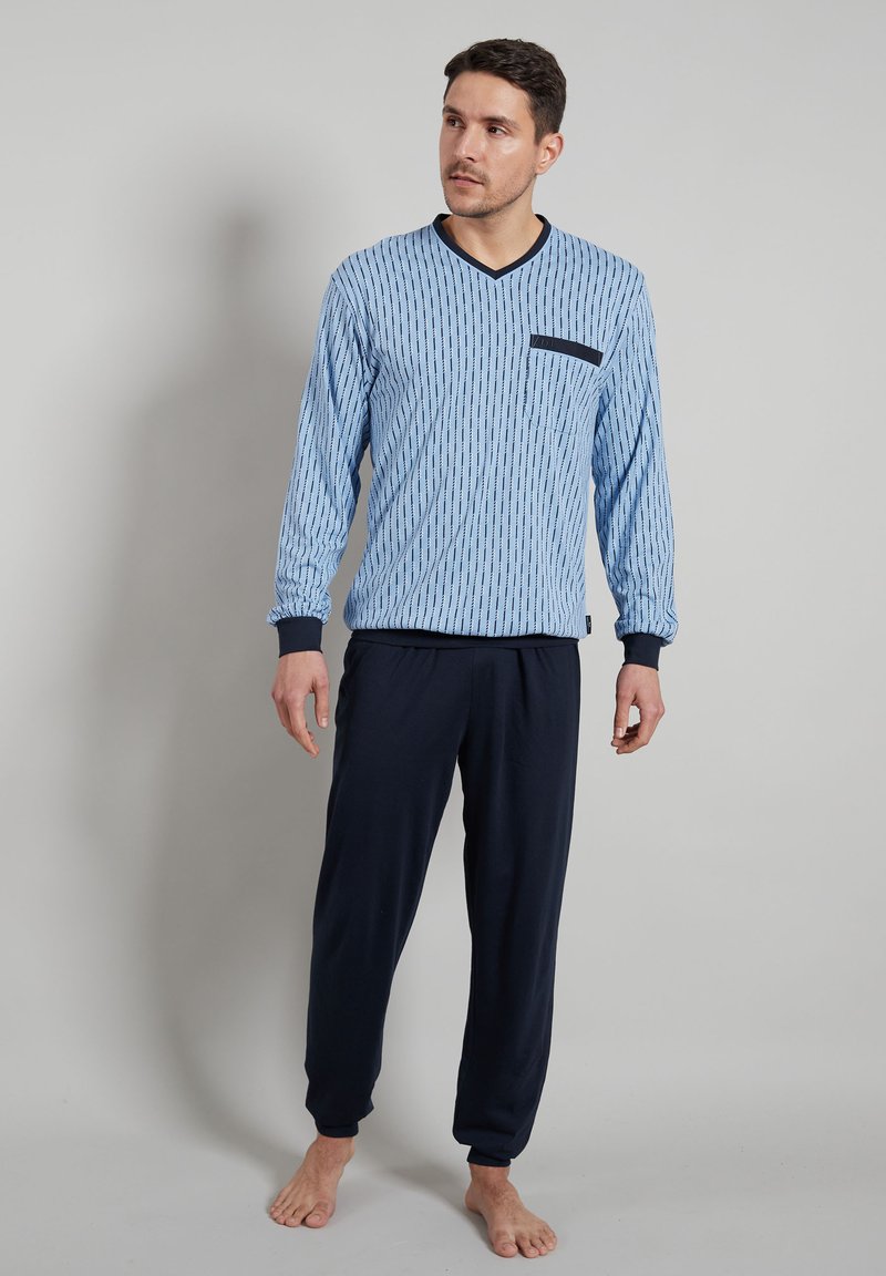 Blue striped long-sleeve V-neck top with a black pocket, paired with navy drawstring trousers. Soft fabric, relaxed fit, and ribbed cuffs.