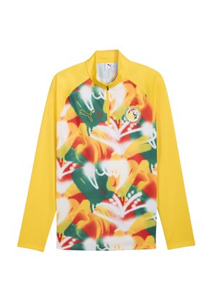 Żółty pulower z długim rękawem i przednim zamkiem na pół, kolorowy abstrakcyjny wzór z przodu, logo Puma na piersi oraz emblemat drużyny piłkarskiej Senegalu.