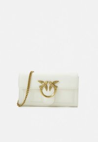 Bílá kožená kabelka do ruky se zlatým řetízkovým popruhem a zlatou sponou zdobenou dvěma ptáky tvář�í v tvář, kteří tvoří kruhový motiv.