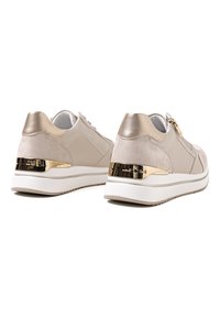 Sneaker beige realizzati in suede e pelle liscia, con un accento in metallo dorato sul tallone e una suola in gomma bianca.