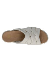White braided slide sandal with a smooth, rubber-like upper, open toe design, and a textured beige insole, featuring subtle branding.