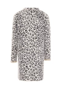 Leopardmönstrad jacka i mjukt, lurvigt tyg med en krämfärgad botten och svarta fläckar. Har långa ärmar och utsmyckade manschetter.