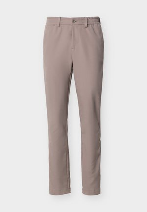 Béžové nohavice slim fit s gombíkom a zipsovým zapínaním, s pútkami na opasok a bočnými vreckami, zobrazené na bielom pozadí.