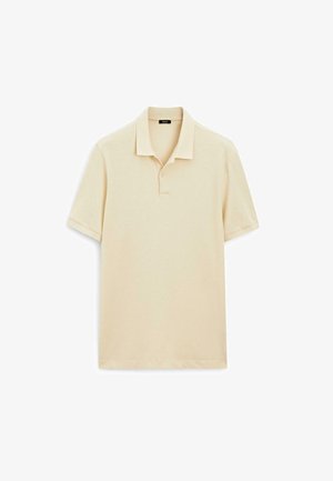 Polo beige con colletto classico, maniche corte e un morbido tessuto di cotone testurizzato. Include un dettaglio con due bottoni.