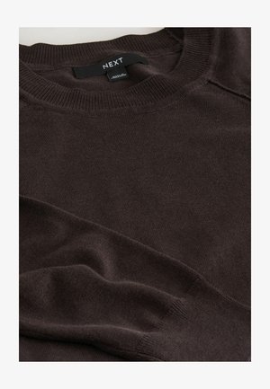 Brown knitted sweater with a crew neckline and long sleeves, featuring a smooth texture and subtle ribbing at the collar. Brand label visible.