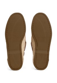 Light tan suede shoe with a soft texture, rubber sole featuring a wavy grip pattern, and brown accents along the edges, logo visible.