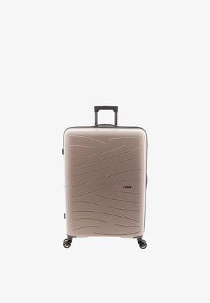 Valigia rigida beige con motivo a onde testurizzato, quattro ruote girevoli e manico telescopico nero estensibile.