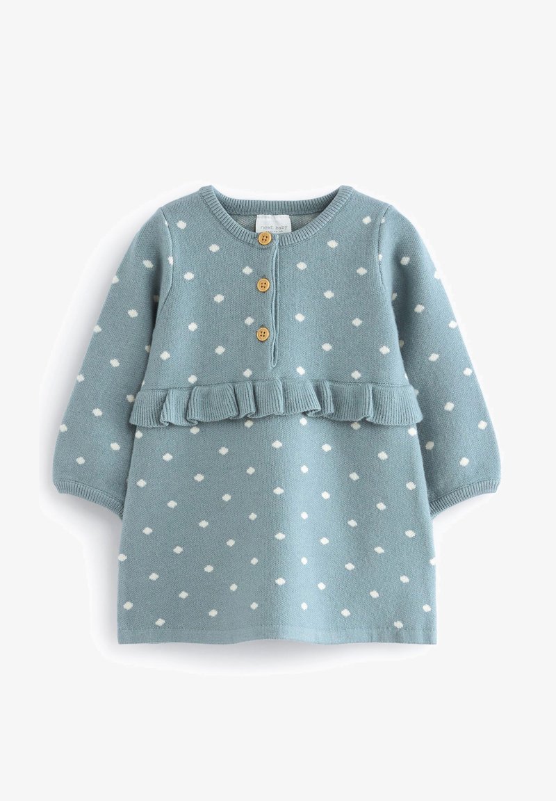 Robe tricotée bleu clair à pois blancs, taille froncée avec volants, et trois boutons en bois à l'avant. Manches longues et col rond.