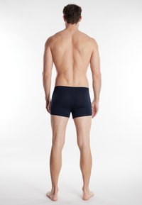 Marineblauwe boxershorts gemaakt van zachte, rekbare stof, met een eenvoudig ontwerp zonder zichtbare patronen of hardwaredetails.