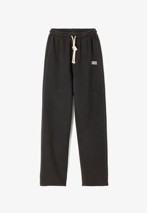 Pantaloni della tuta neri realizzati in tessuto morbido, con una cintura elastica dotata di lacci e un piccolo logo stampato sulla coscia.