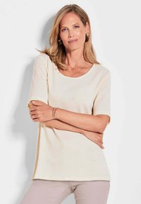 Cremfarbener, gerippter Kurzarm-Top mit rundem Ausschnitt und lockerer Passform. Verfügt über eine dezente Textur und einen geraden Saum.