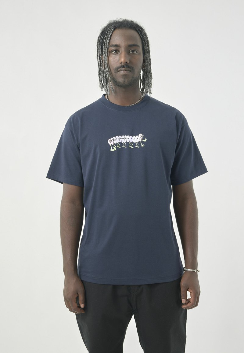 Navy cotton t-shirt featuring a graphic design of a caterpillar and legs in contrasting colors across the chest. Short sleeves and crew neck.