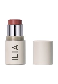 ILIA Creme Blush Stick in einer matten beigen Verpackung mit silbernen Akzenten. Oben befindet sich ein runder, pfirsichfarbener Pinsel. Deckel an der Seite.