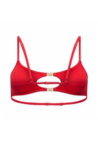 Bralette rouge avec bretelles fines réglables, deux fermoirs dorés centrés dans le dos et une sangle horizontale sous la poitrine.