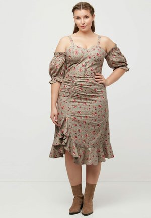 Blumendruckkleid mit schulterfreien Puffärmeln, gerafftem Design, knielangem Saum und einem Rüschensaum. Hergestellt aus einem weichen, strukturierten Stoff.