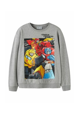Sweat-shirt gris avec les personnages colorés Transformers Bumblebee, Optimus Prime et Hot Rod, avec le texte "Transformers The Movie" au-dessus.