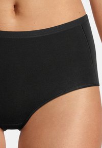 Mutande nere a vita alta realizzate in un materiale liscio e elastico, con cuciture piatte per il massimo comfort e un design senza giunte.