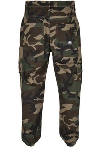 Camo cargo pants made of durable fabric, featuring a green, brown, and black camouflage pattern, multiple pockets, and tapered cuffs.