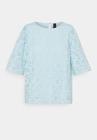 Lyseblå top med rund halsudskæring og korte pufærmer, prydet med blomstermønstre i udskæringer over det hele og en nøglehul detalje på ryggen.