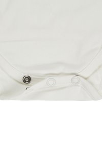 White fabric with three metal snap fasteners, one closed and two open, on a garment edge seam.