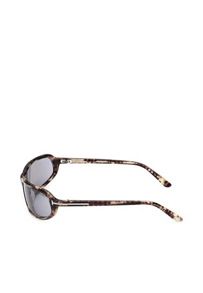 Tortoiseshell-patterned sunglasses with dark tinted lenses shown from side angle on white background.