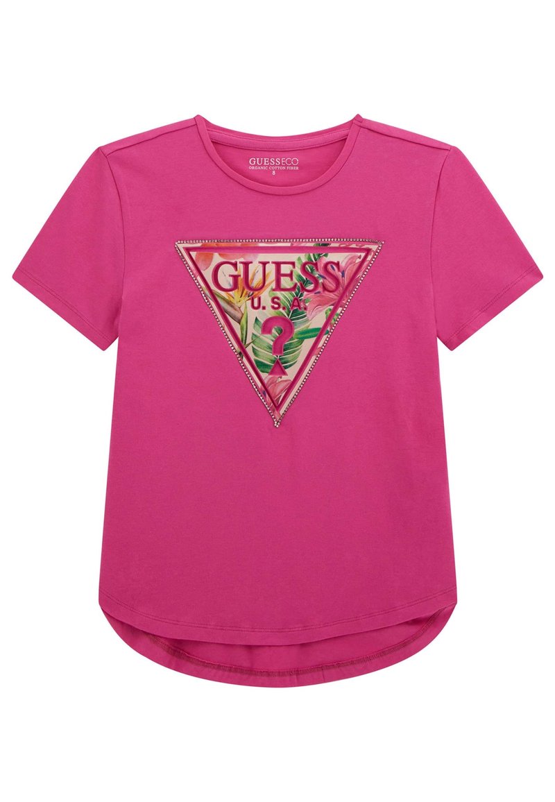 T-shirt rose à manches courtes en coton biologique, présentant un graphique triangulaire avec des feuilles tropicales et le texte "GUESS U.S.A.", orné de clous.