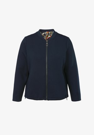 Navy blue zip-up jacket with a round collar, side pockets, and a colorful patterned lining inside. Made from soft, textured fabric.