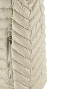 Gilet imbottito in bianco sporco, con motivo a zigzag, chiusura con zip laterale e una texture morbida e liscia.