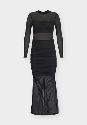 Μακρύ μαύρο διάφανο φόρεμα από τούλι με ψηλό λαιμό, μακριά μανίκια, ραβδώσεις στη μέση και ημιδιάφανο κάτω μέρος φούστας.